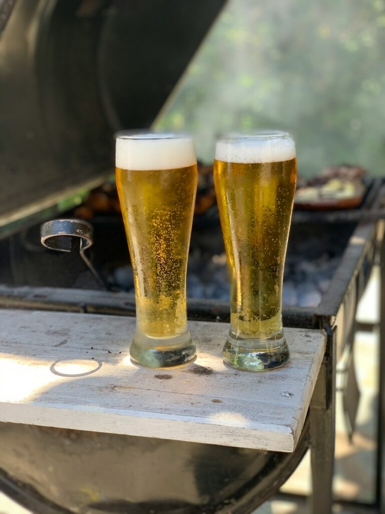 two pilsners filled with beer