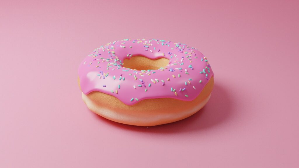 pink doughnut with pink icing on top
