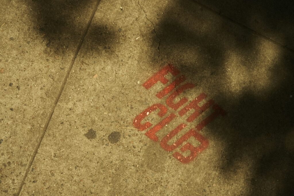 The shadow of a person standing on a sidewalk