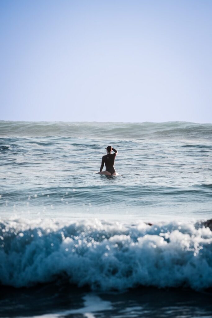 a man riding a wave on top of a surfboard